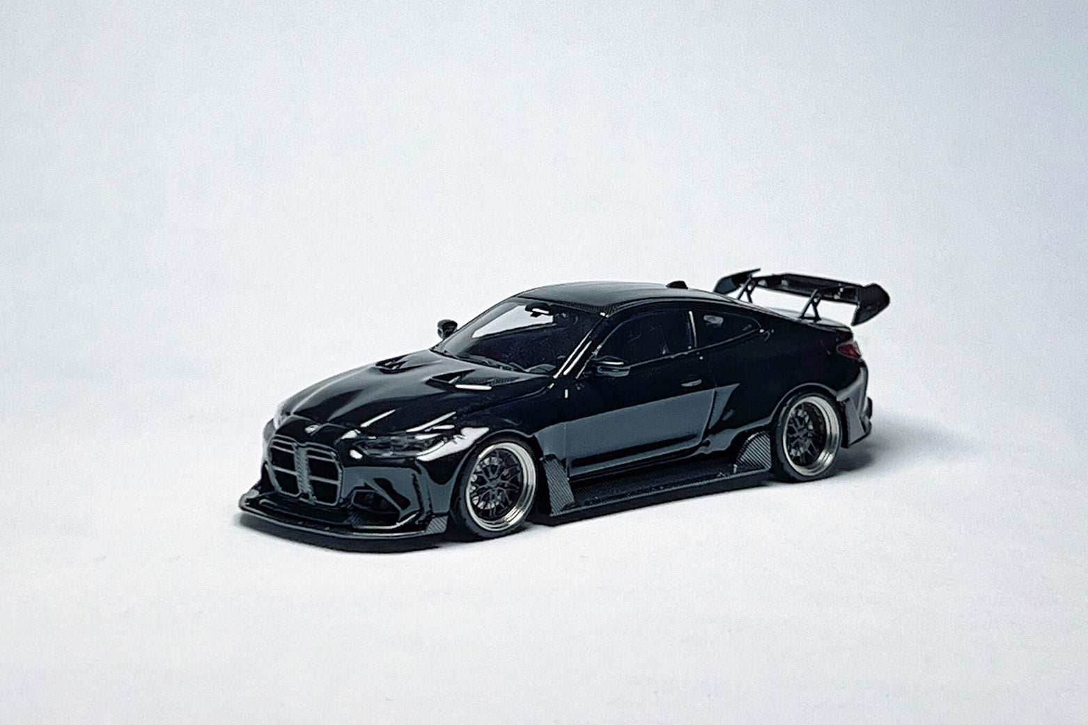 1:64 scale SW BMW G82 M4 ADRO widebody metallic black custom diecast with deep-dish bearing wheels