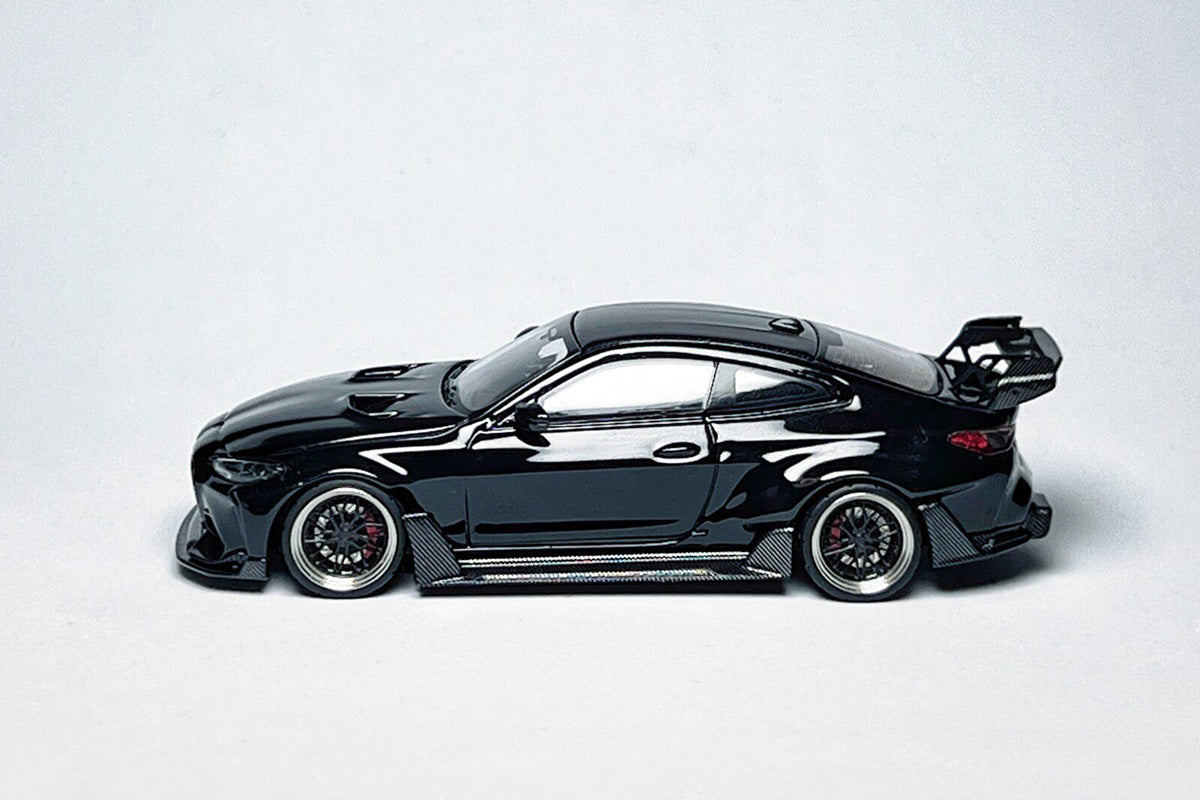 Custom 1:64 BMW G82 M4 ADRO widebody metallic black diecast model with deep-dish bearing wheels