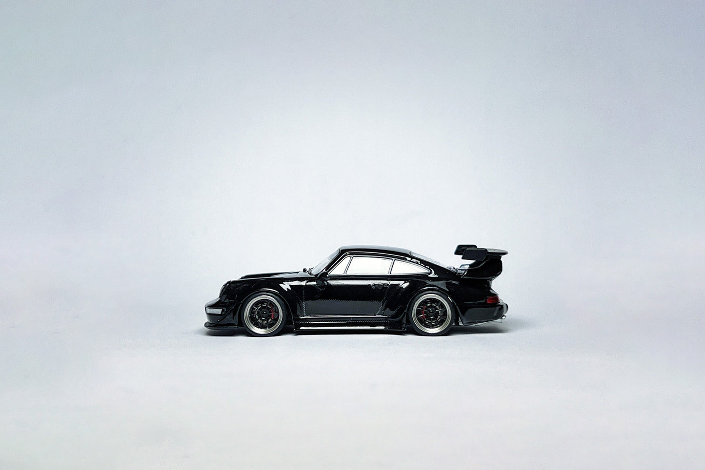 Wheel and rim detail on custom 1:64 Porsche RWB 964 Black Bird diecast with deep-dish bearing wheels