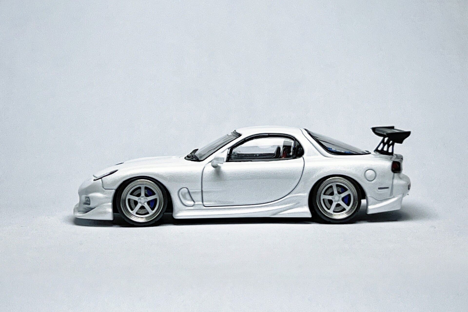 Custom 1:64 Mazda RX-7 VeilSide pearl white diecast model with deep-dish bearing wheels
