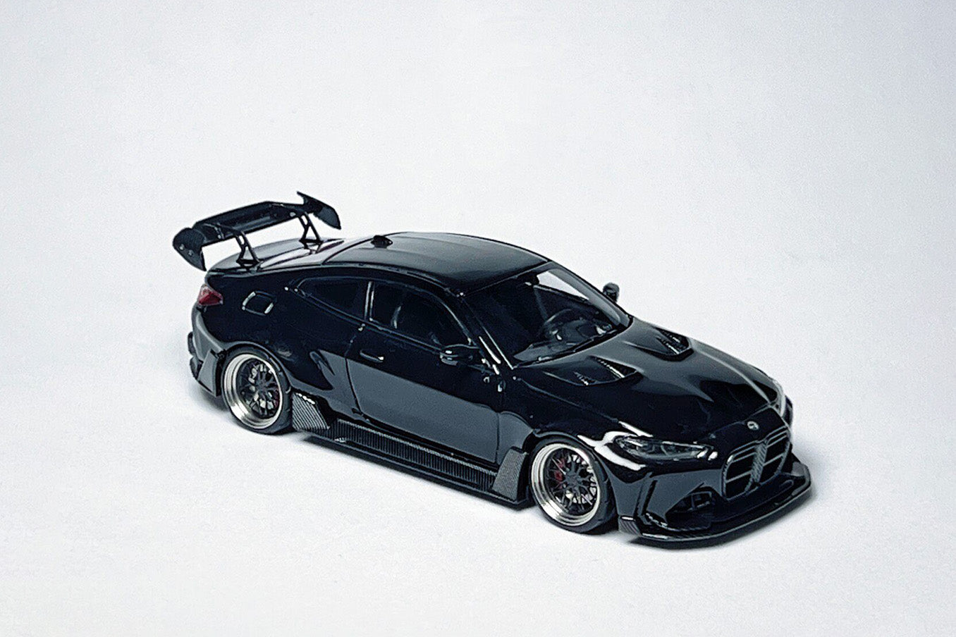 1:64 BMW G82 M4 ADRO widebody metallic black custom diecast with deep-dish bearing wheels