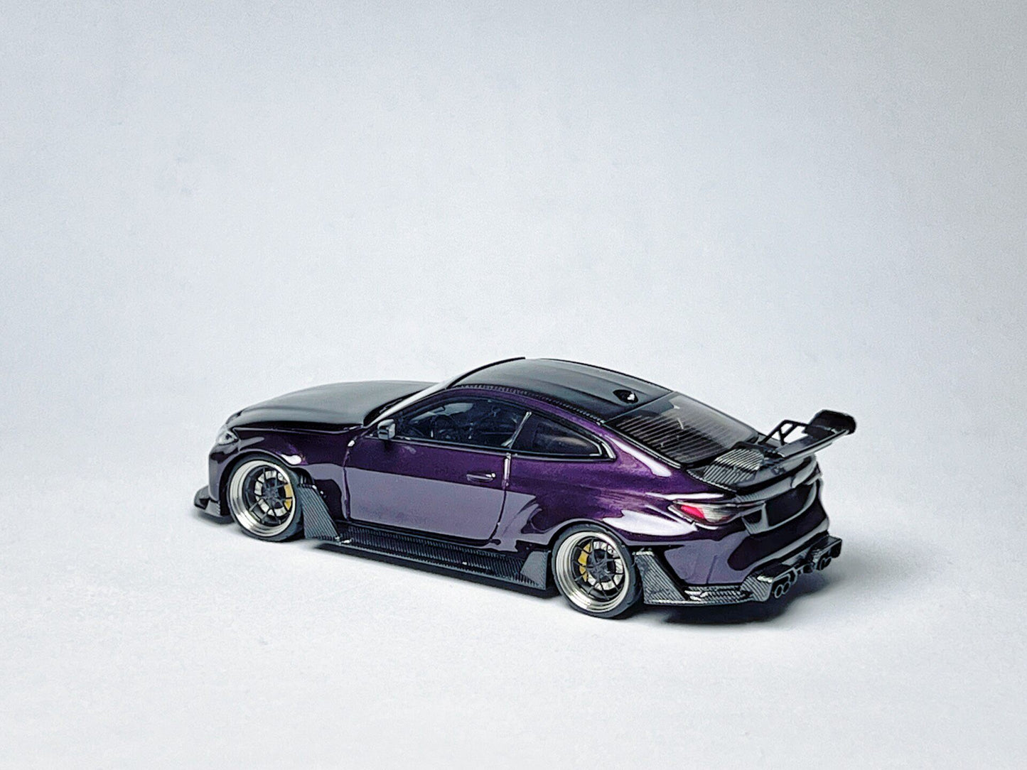 1:64 BMW G82 M4 ADRO widebody purple custom diecast with visible wheel and rim detail