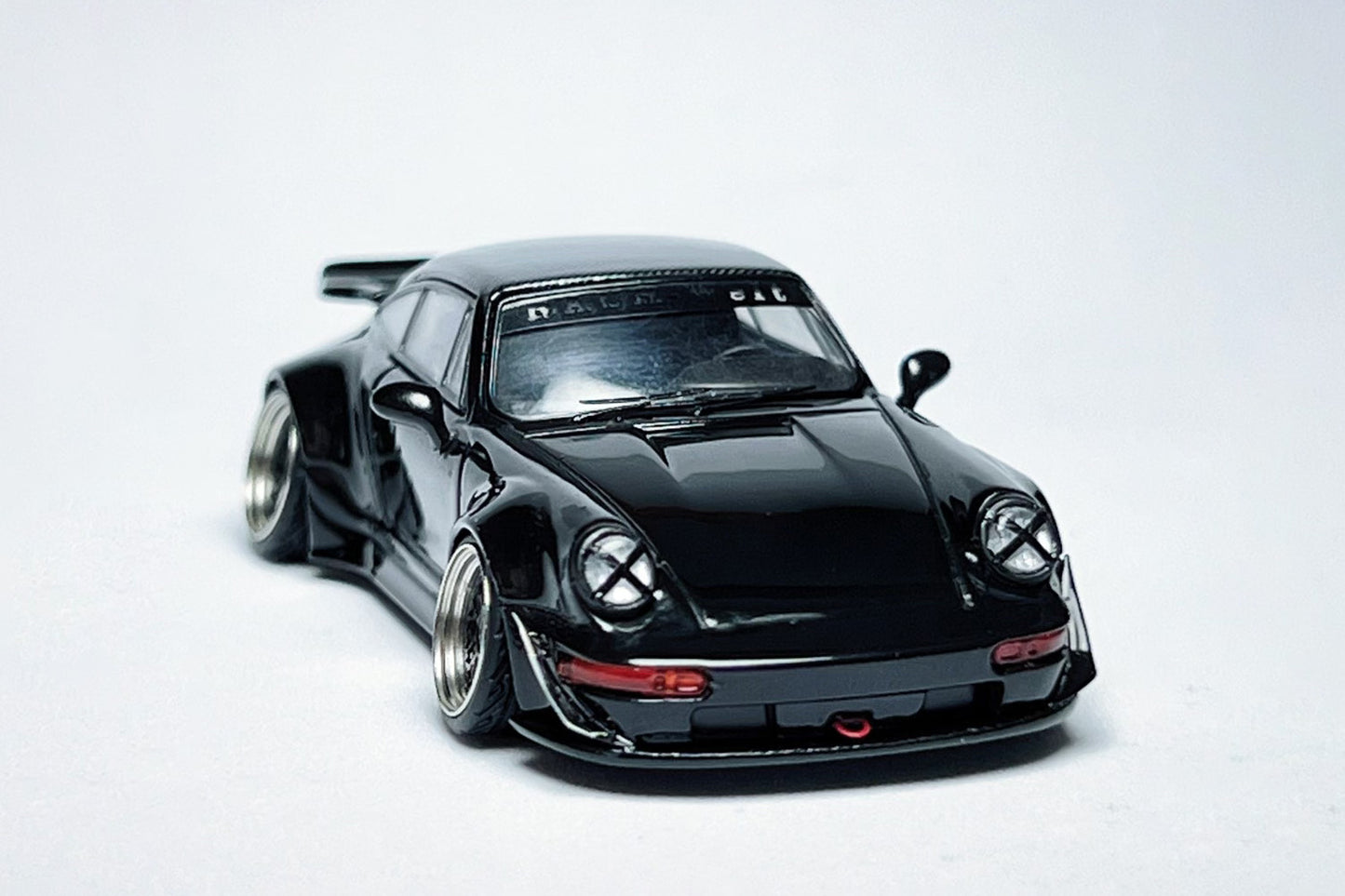 Custom 1:64 Porsche RWB 964 Ducktail Black Bird diecast model with deep-dish bearing wheels