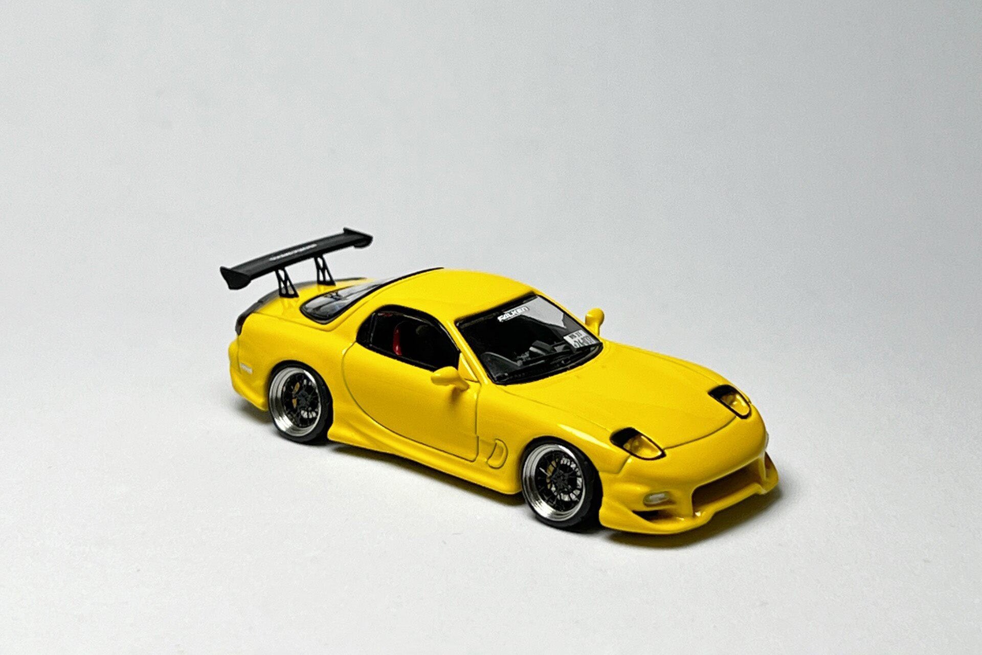 Custom 1:64 Mazda RX-7 VeilSide yellow diecast model with deep-dish bearing wheels