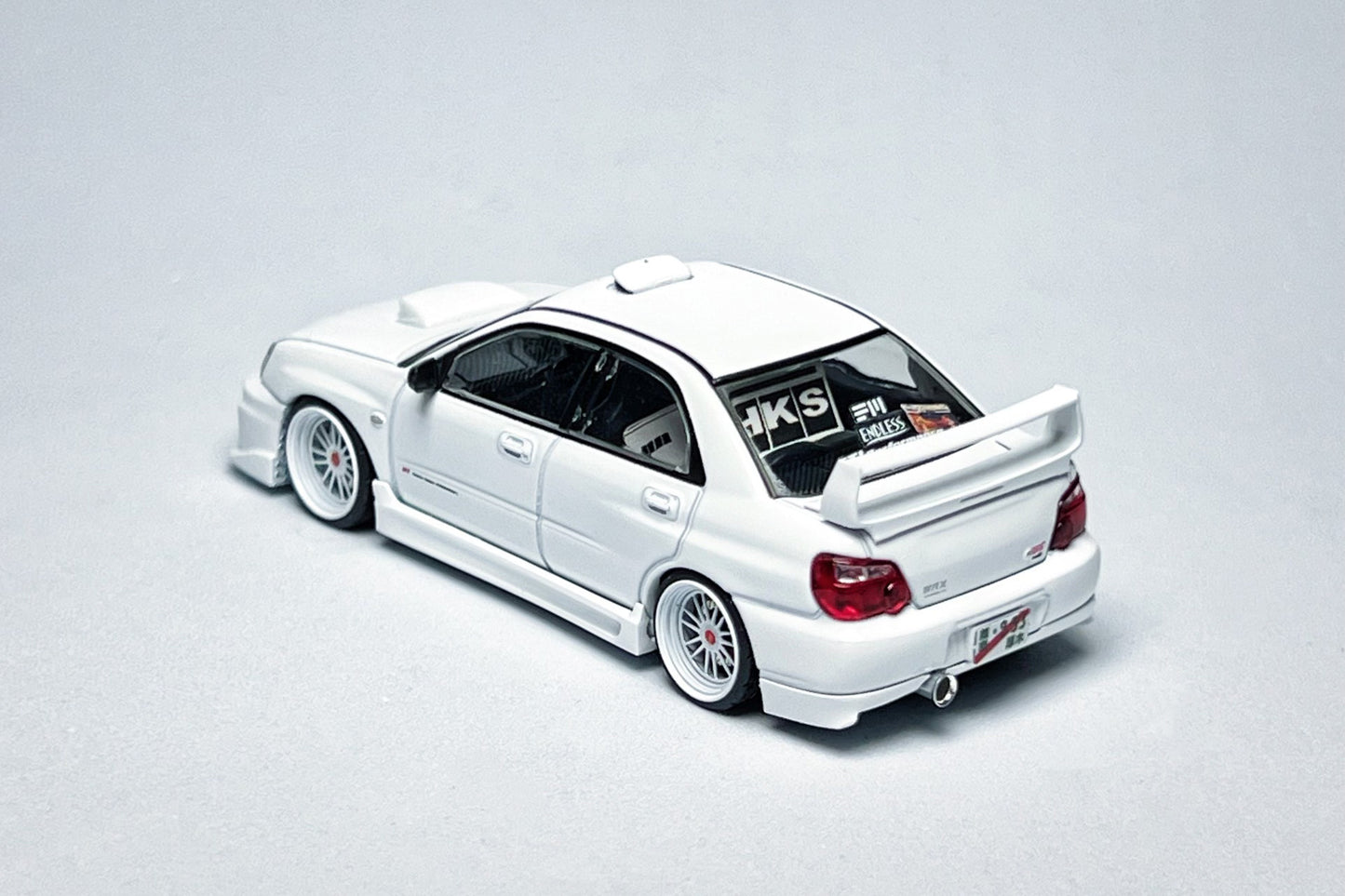 Custom 1:64 Subaru Impreza WRX STI white diecast model with visible text markings