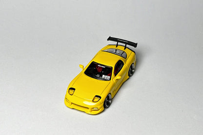 Custom 1:64 Mazda RX-7 VeilSide yellow diecast model with race number markings
